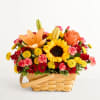 Mixed flower basket with a sunflower, orange lily, and roses
