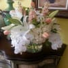 Elegant cylinder filled with white hydrangea blooms, peach french tulips, stock, white