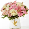 Pink and cream bouquet in a white vase with a gold dove design