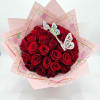 Bouquet of red roses wrapped in pink paper with butterfly decorations