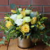 Yellow and white rose bouquet in a gold vase
