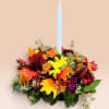Autumn floral centerpiece with a tall white taper candle