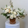 White and peach roses in a wicker basket with pearl trim