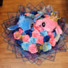 Bouquet of blue and pink roses with two plush characters and butterfly wrap