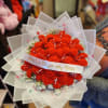 Bouquet of bright orange flowers wrapped in translucent paper