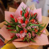 Pink roses and red tulips wrapped in pastel paper