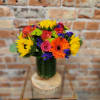 Colorful bouquet with sunflowers, roses, and a gerbera daisy in a glass vase