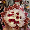 Bouquet of red and white roses wrapped in layered paper