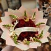 Bouquet of red roses with pink snapdragons and a cream ribbon