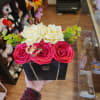 Black gift box with red and white roses and green accents