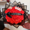Red rose bouquet with black wrap, ribbon, and decorative crowns