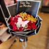 Bouquet of red roses with a butterfly topper and teacher-day card