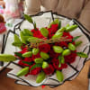Bouquet of red roses and green lily buds with a birthday topper