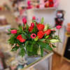 Bouquet of red roses and pink tulips in a glass vase