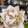 Bouquet of gold satin roses with pink butterfly decorations