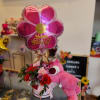 Pink birthday balloon with roses and a teddy bear in a gift box