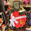 Bouquet of red roses with a graduation cap decoration and white ribbon
