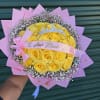 Yellow rose bouquet with pink wrapping and a small crown topper