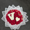 Round bouquet of red roses with white floral letters and butterfly accents