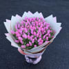 Bouquet of pink tulips wrapped in white and pink paper