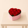 Lush red roses beautifully arranged in a heart-shaped pink box, featuring 8
