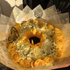 beautiful wrapped bouquet off white and yellow roses with a sunflower and