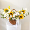 Basket of white and yellow flowers with a white ribbon