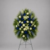 Standing funeral spray with blue and white flowers on an easel
