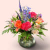 Low and full filled with carnations, roses and veronica