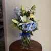 A fresh arrangement in soft blues and calming tones, perfect for welcoming