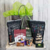 Gift bag filled with snack bags, candy, and a jar of mixed nuts