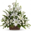 White lilies and carnations in a wicker basket