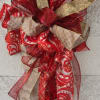 Decorative red, gold, and cream ribbon bow