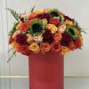 Round bouquet of multicolored roses in a red box
