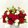 Arrangement of red and white roses with buds in a gray textured ceramic vase.