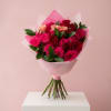 A lush mix of pink, red and soft peach roses creates an