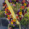 Heart-shaped floral wreath on an easel with a yellow ribbon