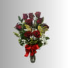 Bouquet of red roses with baby's breath in a glass vase and red ribbon