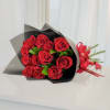 Bouquet of red roses wrapped in black paper with a red ribbon