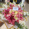 Pink and cream bouquet with lilies and roses wrapped in white paper