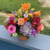 Colorful mixed bouquet in a small terracotta pot