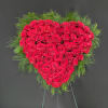 A solid heart standing spray covered in beautiful roses. Colors and arrangement
