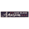 Long rustic wooden sign reading God Bless America with red stars on a dark background