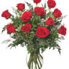 Red roses arranged in a clear glass vase