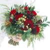 Bouquet of red roses with mixed greenery and white berries