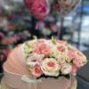 Pink and cream rose bouquet in a pastel hat box with a ribbon