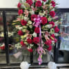 Standing floral spray with pink roses, lilies, and white filler flowers