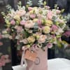 Pink and cream bouquet in a round pink box with ribbon