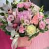 Pink floral basket with roses, orchids, and daisies