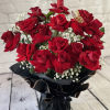 Bouquet of red roses with baby's breath in black wrap